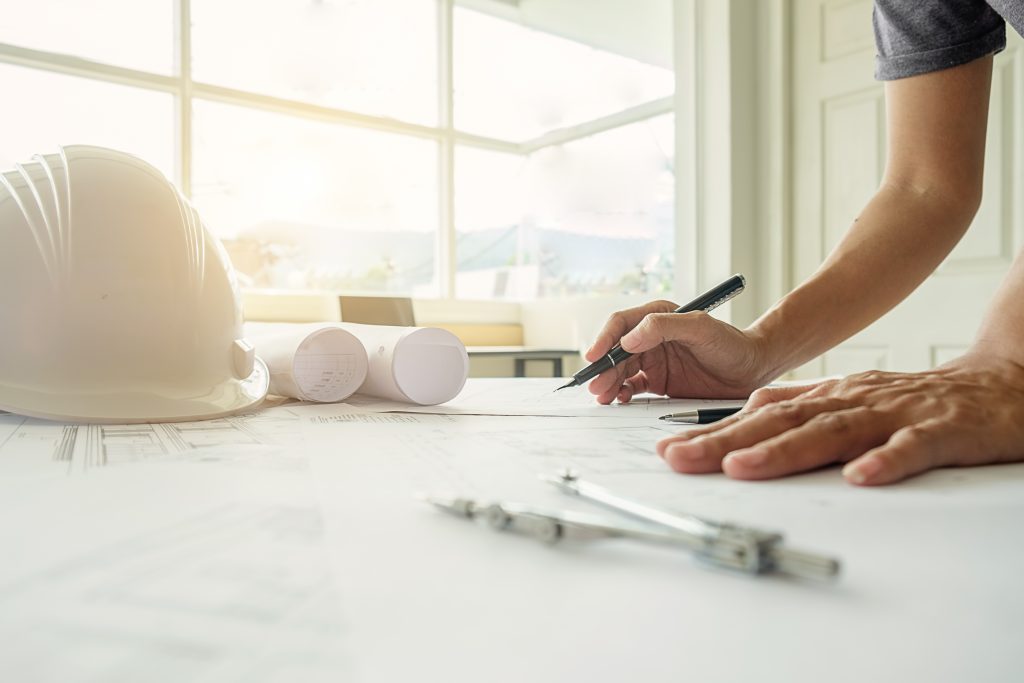 hands of engineer working on blueprint,construction concept. eng